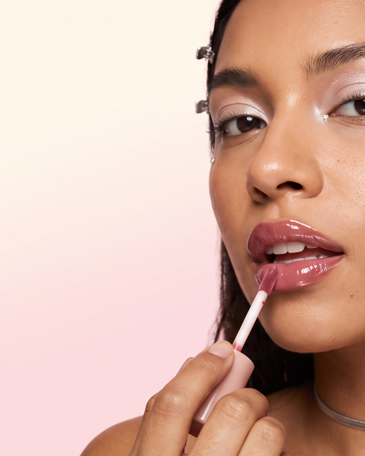 Five hince lip tint tubes on a cream surface against a bubblegum-pink backdrop